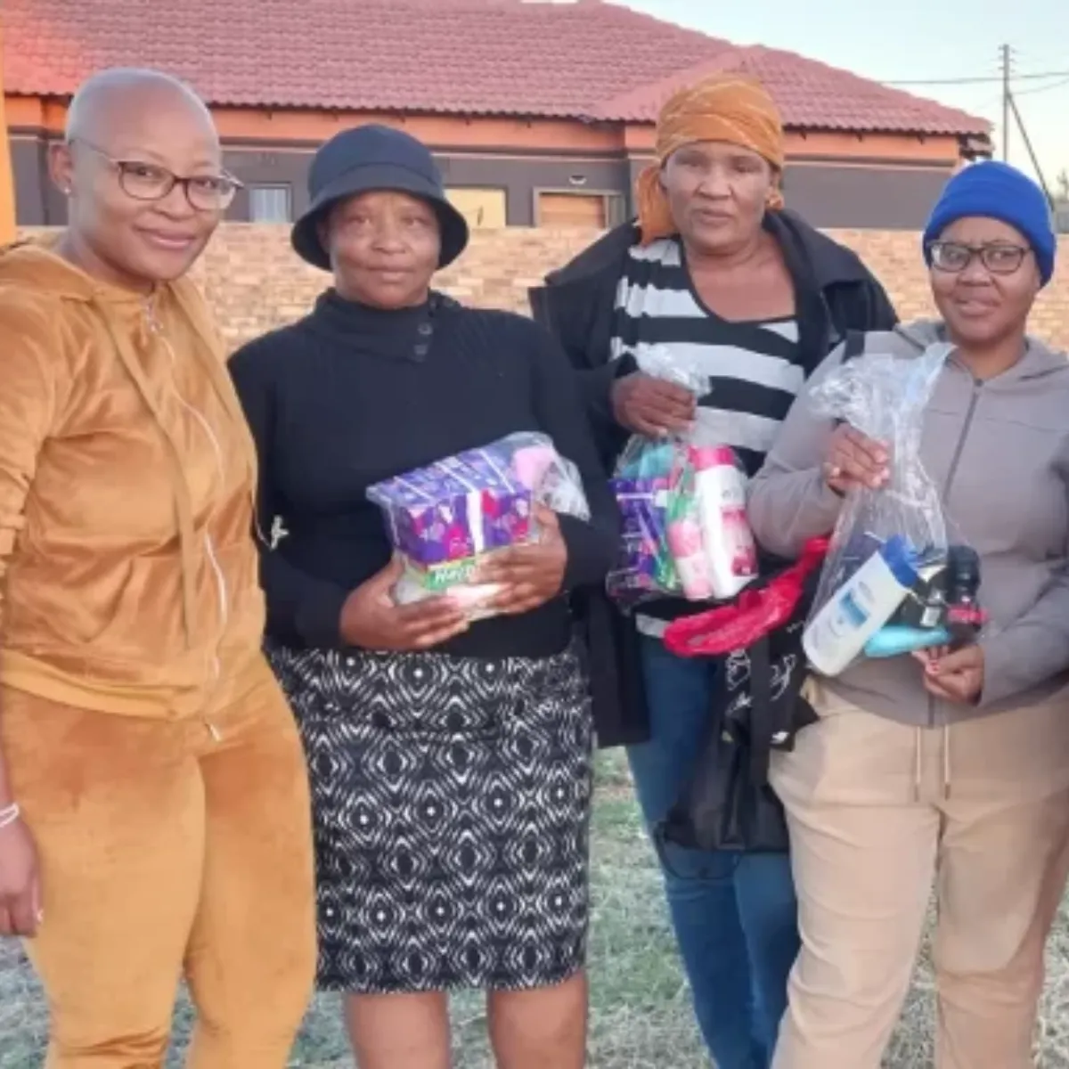 Noms Drive team distributing hygiene and care packages to community members in South Africa