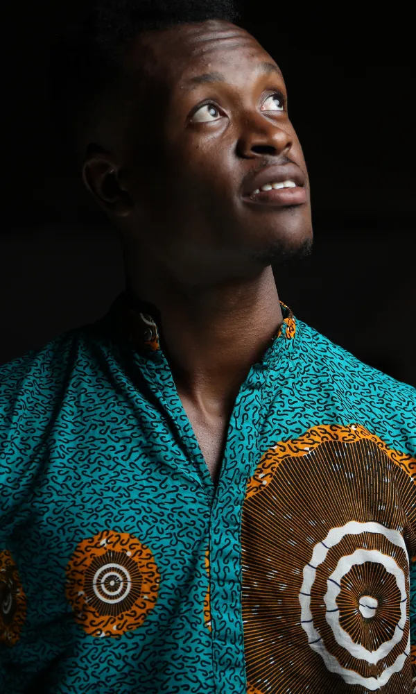 Young man looking upward representing hope, growth and community support initiatives in South Africa