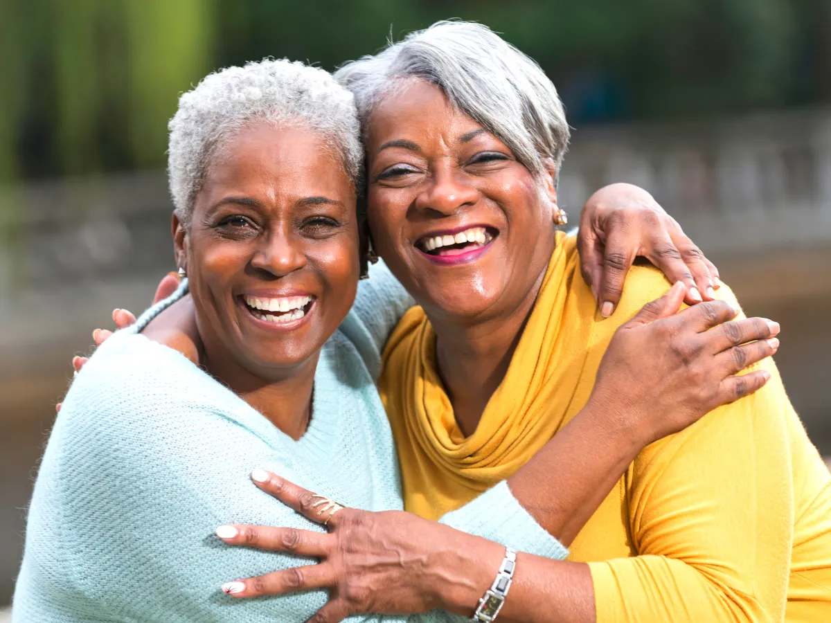 Elderly women smiling during senior citizens community support event in South Africa